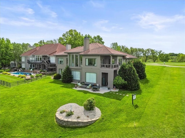 rear view of property featuring a patio, stucco siding, a chimney, and outdoor lounge area