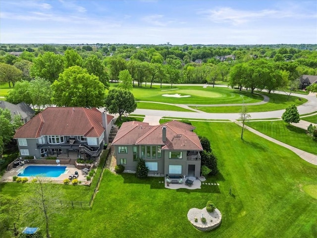 view of subject property featuring a pool and a tree filled landscape