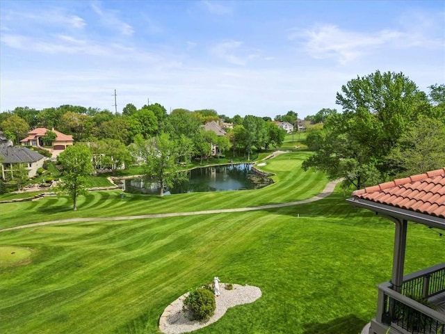 surrounding community featuring a water view, view of golf course, and view of scattered trees
