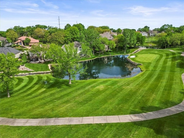 view of community with a water view, view of golf course, and a lawn