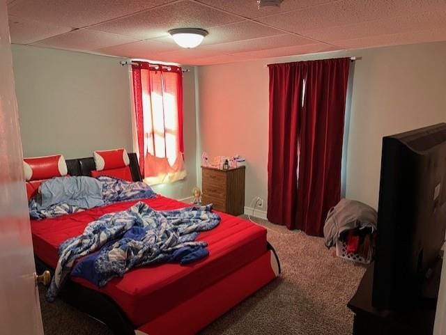 carpeted bedroom with a paneled ceiling