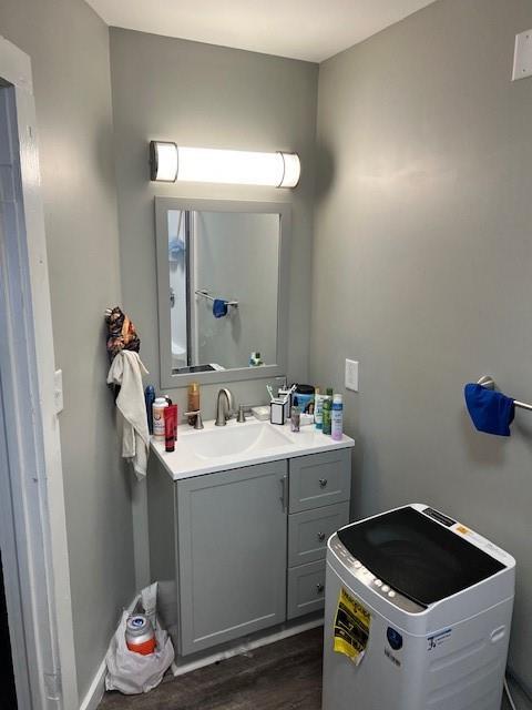 bathroom with wood finished floors and vanity