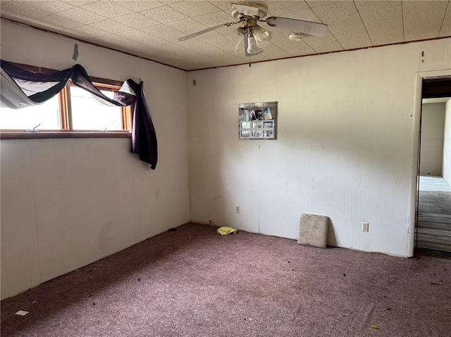 empty room with a ceiling fan and carpet floors
