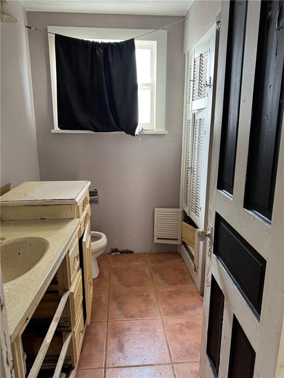bathroom featuring tile patterned floors, toilet, and vanity