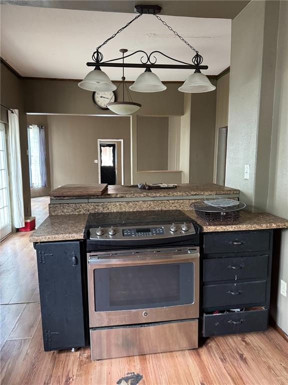 kitchen with stainless steel range with electric stovetop and light wood finished floors