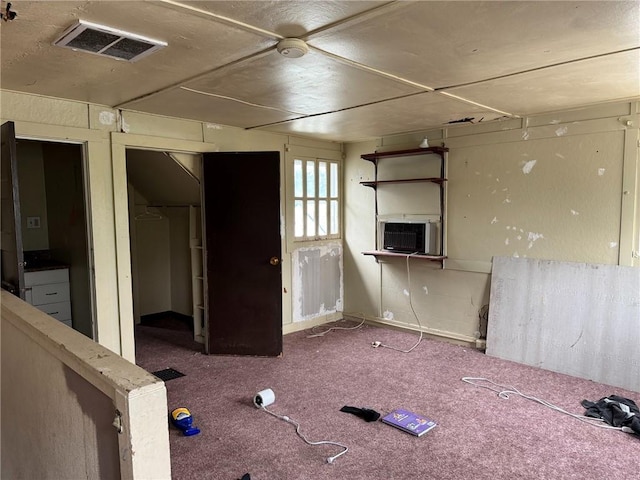 carpeted spare room with cooling unit and visible vents