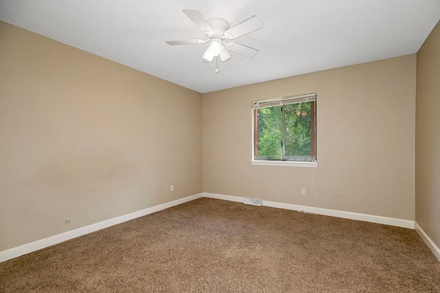 carpeted empty room with baseboards and ceiling fan