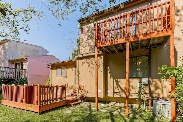 back of property featuring a wooden deck and central AC