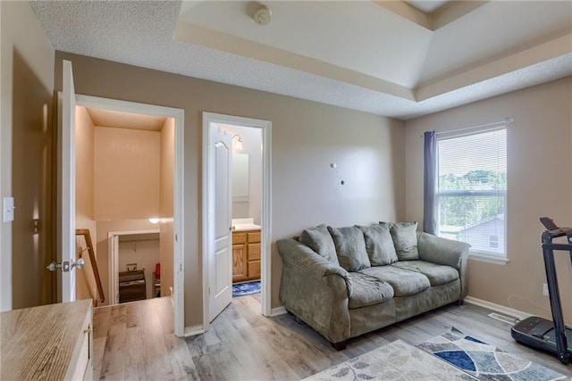 8403 NE 115th Ter, Kansas City, MO 64157 - living room with wood finished floors, a raised ceiling, and baseboards