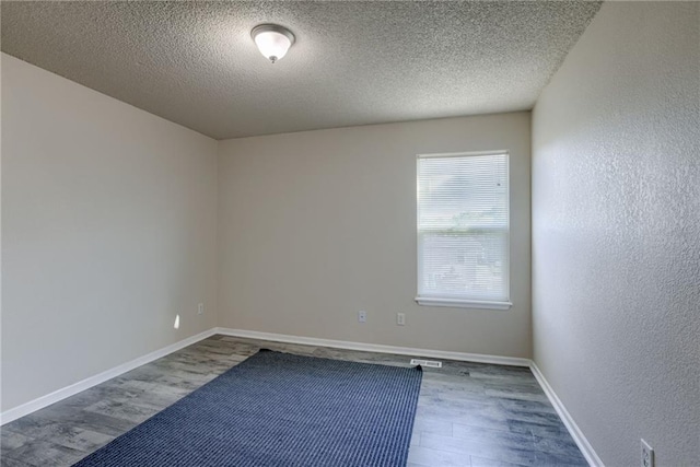 8403 NE 115th Ter, Kansas City, MO 64157 - empty room with dark wood-style floors, a textured ceiling, and baseboards