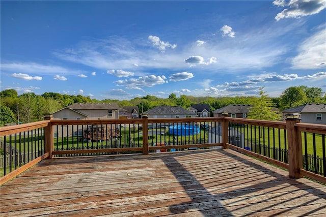 8403 NE 115th Ter, Kansas City, MO 64157 - wooden deck featuring a residential view and a lawn