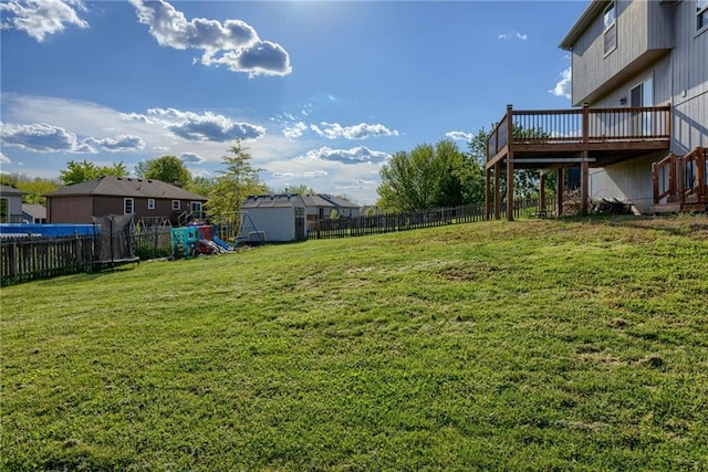 8403 NE 115th Ter, Kansas City, MO 64157 - view of yard featuring a wooden deck and a playground