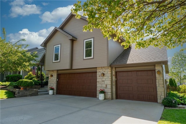 9808 N Hedges Ave, Kansas City, MO 64157 - view of front facade featuring stone siding, concrete driveway, a garage, and a shingled roof