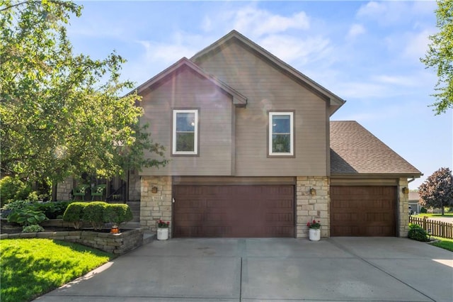 9808 N Hedges Ave, Kansas City, MO 64157 - view of front of property with stone siding, driveway, and an attached garage