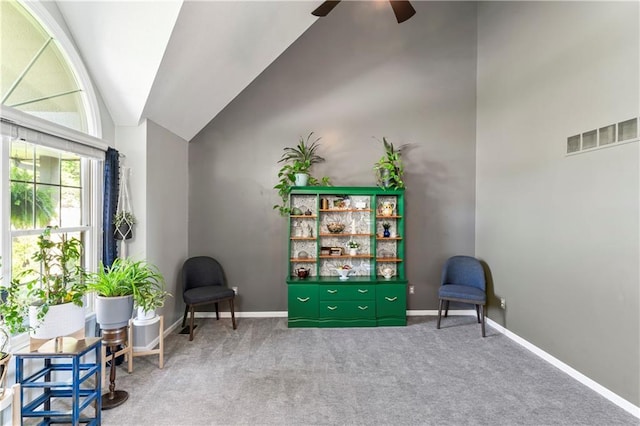 9808 N Hedges Ave, Kansas City, MO 64157 - living area with ceiling fan, carpet floors, baseboards, and high vaulted ceiling