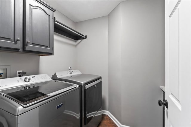 9808 N Hedges Ave, Kansas City, MO 64157 - clothes washing area featuring washing machine and dryer, cabinet space, and baseboards