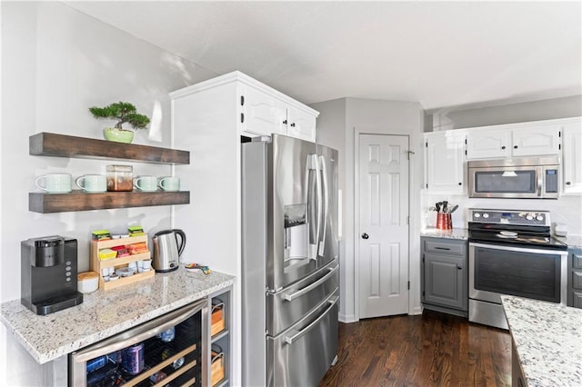 9808 N Hedges Ave, Kansas City, MO 64157 - kitchen featuring appliances with stainless steel finishes, open shelves, white cabinetry, and dark wood-type flooring