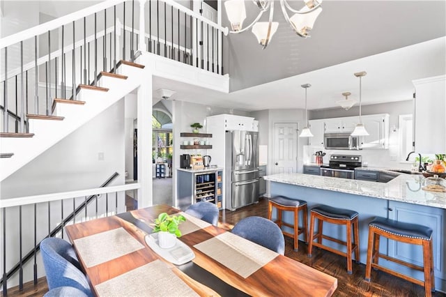 9808 N Hedges Ave, Kansas City, MO 64157 - dining area featuring a chandelier and a towering ceiling