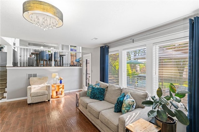 9808 N Hedges Ave, Kansas City, MO 64157 - living area featuring wood finished floors, baseboards, and a chandelier