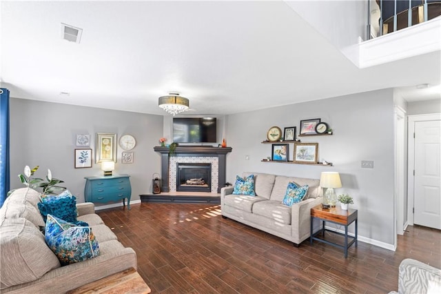 9808 N Hedges Ave, Kansas City, MO 64157 - living area featuring wood finished floors, a stone fireplace, and baseboards
