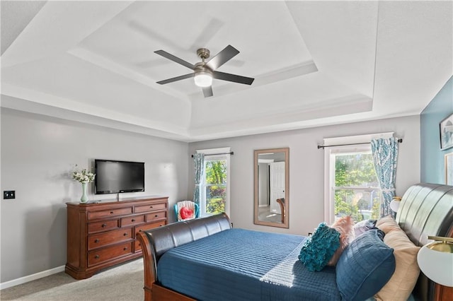 9808 N Hedges Ave, Kansas City, MO 64157 - bedroom featuring a raised ceiling, light colored carpet, and multiple windows
