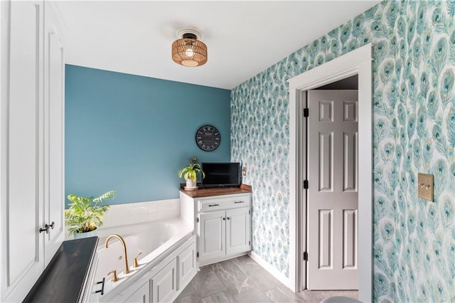 9808 N Hedges Ave, Kansas City, MO 64157 - bathroom with wallpapered walls, a garden tub, and baseboards