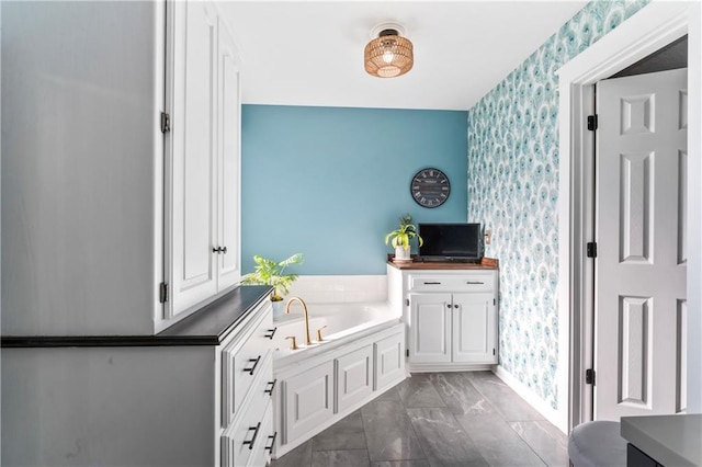 9808 N Hedges Ave, Kansas City, MO 64157 - full bath with wallpapered walls, a garden tub, an accent wall, and marble look tiles