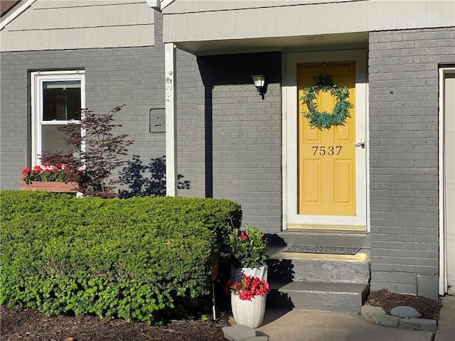 entrance to property with brick siding