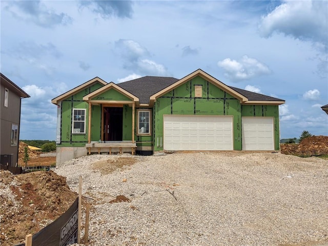 10026 Aurora St, Lenexa, KS 66220 - unfinished property with driveway and a garage