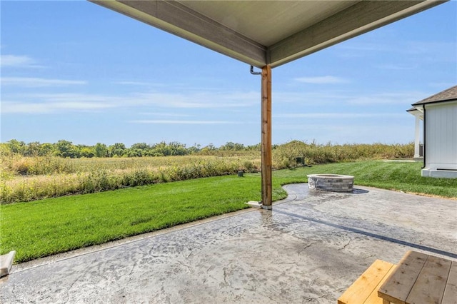 view of patio / terrace with an outdoor fire pit and a rural view