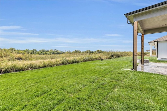 view of yard featuring a rural view and a patio area