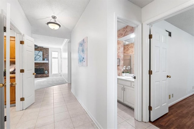 7955 W 118th Pl, Overland Park, KS 66210 - hallway featuring light tile patterned flooring and a textured ceiling