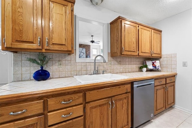 7955 W 118th Pl, Overland Park, KS 66210 - kitchen with dishwasher, tile counters, brown cabinets, and a textured ceiling