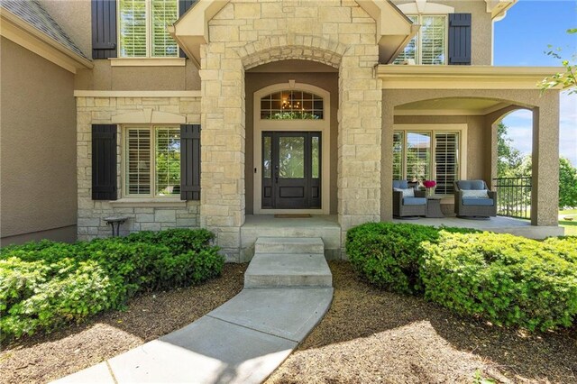 8701 W 157th St, Overland Park, KS 66221 - entrance to property with stucco siding, stone siding, and a porch