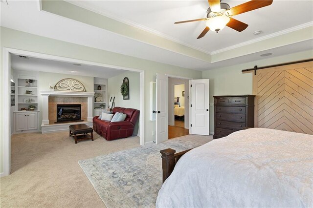 8701 W 157th St, Overland Park, KS 66221 - carpeted bedroom featuring ornamental molding, a high end fireplace, a barn door, ceiling fan, and baseboards
