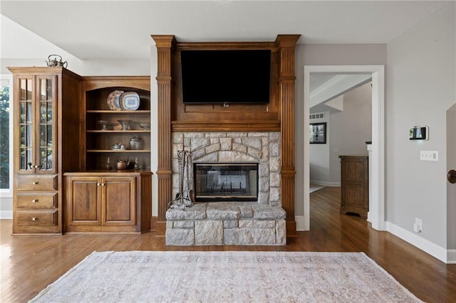 8701 W 157th St, Overland Park, KS 66221 - living room featuring wood finished floors, baseboards, and a fireplace