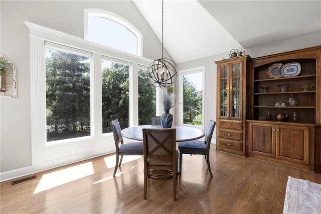 8701 W 157th St, Overland Park, KS 66221 - dining area featuring a chandelier, dark wood-style floors, and high vaulted ceiling