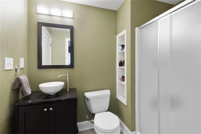 8701 W 157th St, Overland Park, KS 66221 - full bathroom featuring vanity, a stall shower, toilet, and baseboards