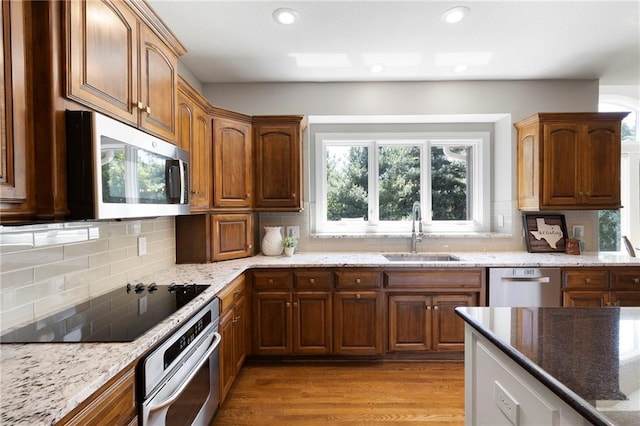8701 W 157th St, Overland Park, KS 66221 - kitchen with appliances with stainless steel finishes, a sink, light stone countertops, tasteful backsplash, and recessed lighting