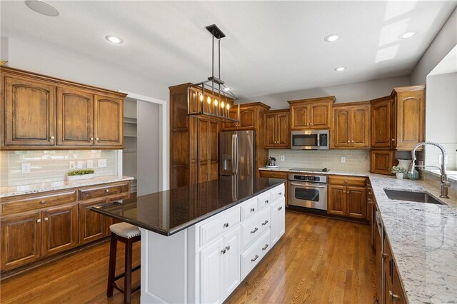 8701 W 157th St, Overland Park, KS 66221 - kitchen with stainless steel appliances, a sink, white cabinets, decorative backsplash, and recessed lighting