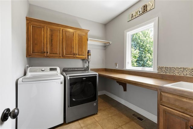 8701 W 157th St, Overland Park, KS 66221 - washroom featuring cabinet space, washer and dryer, light tile patterned flooring, and baseboards