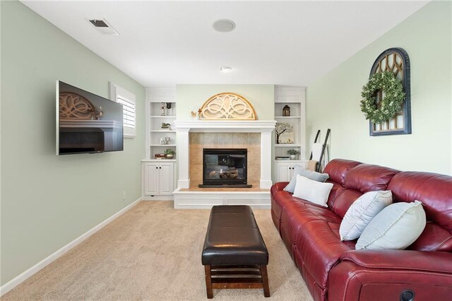 8701 W 157th St, Overland Park, KS 66221 - living area with a tile fireplace, baseboards, carpet, and built in shelves