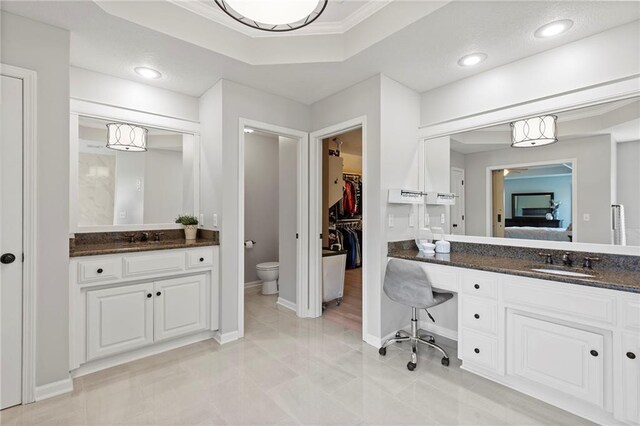 8701 W 157th St, Overland Park, KS 66221 - ensuite bathroom with vanity, crown molding, baseboards, a walk in closet, and toilet