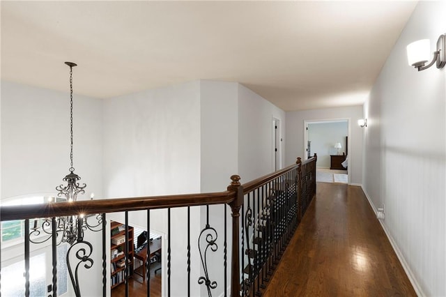 8701 W 157th St, Overland Park, KS 66221 - hallway with a chandelier, wood finished floors, and baseboards