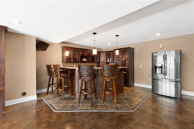 8701 W 157th St, Overland Park, KS 66221 - bar with stainless steel fridge with ice dispenser, finished concrete flooring, baseboards, recessed lighting, and hanging light fixtures