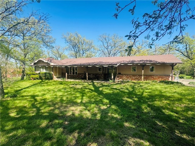 back of house with a yard and a carport