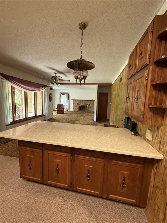 kitchen with brown cabinets, open shelves, a textured ceiling, ceiling fan, and light countertops