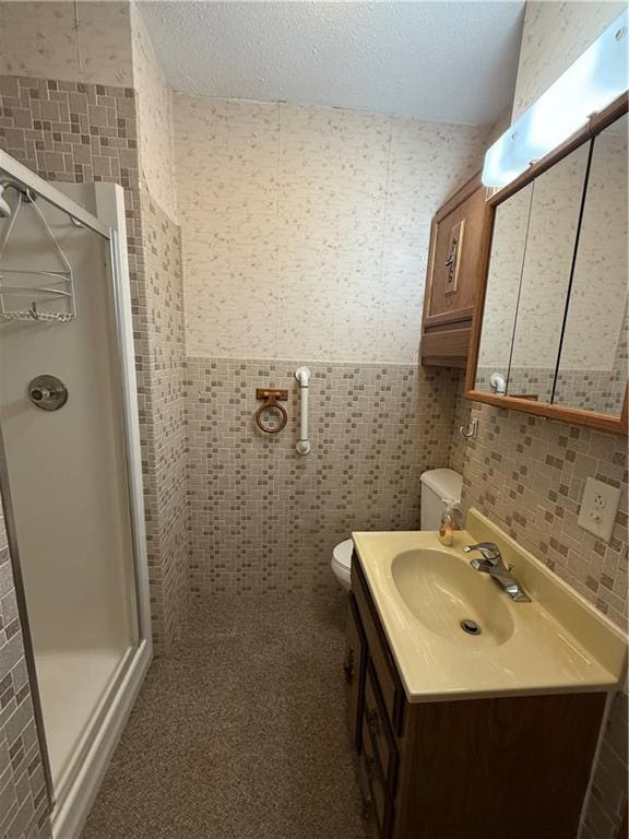 full bathroom featuring tile walls and a stall shower