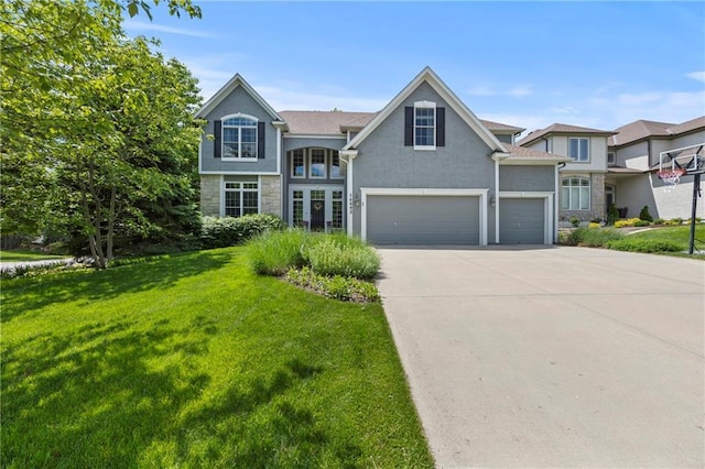 14692 S Garnett St, Olathe, KS 66062 - traditional home featuring a front yard, stone siding, concrete driveway, stucco siding, and a garage