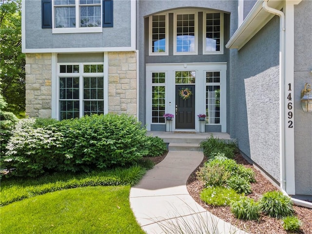 14692 S Garnett St, Olathe, KS 66062 - view of exterior entry featuring stucco siding and stone siding